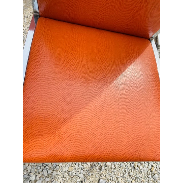 This is a set of six mid century vintage dining chairs. These chairs are upholstered In a dark rust orange faux snake skin...