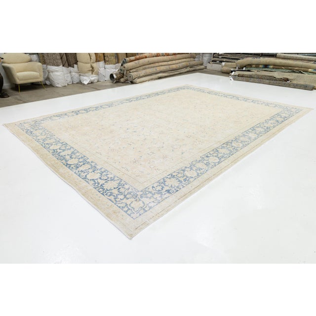 This stunning Antique Persian Kerman rug features a delicate ivory and cream field adorned with an all-over floral pattern...