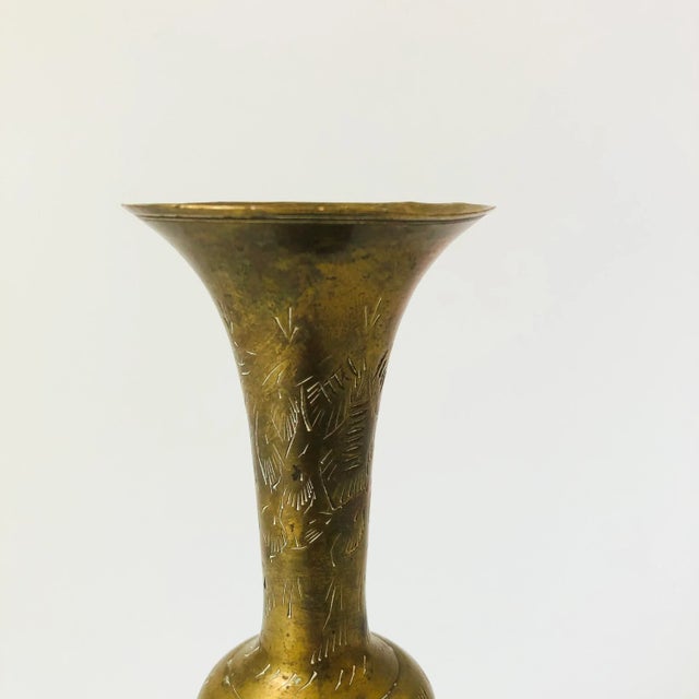 A vintage brass vase with a lovely etched floral design to the surface.