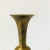 A vintage brass vase with a lovely etched floral design to the surface.