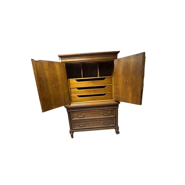 Chic vintage Thomasville armoire from the 1970s featuring iconic Greek key detailing in a glamorous Hollywood Regency...