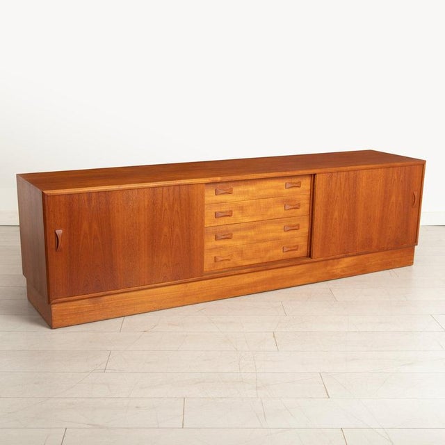 Danish Mid Century teak low sideboard with sliding doors by Clausen & Son, circa 1970s. Fully restored. H: 60cm W: 209cm...