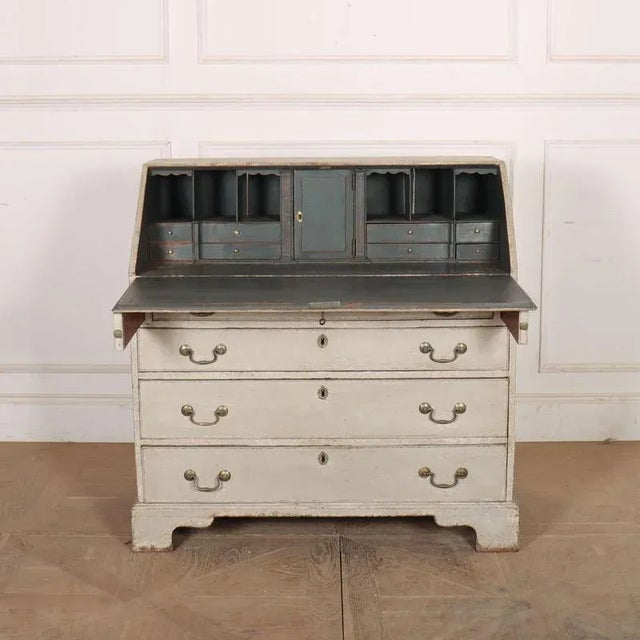 19th century English painted oak bureau. 1880. Height to underside of desk: 28.5-inches (72cm) This piece is designed in...