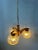 Mid century German glass chandelier. The pendant lamp has three clear glass in slightly smoked yellowish colour. The frame...