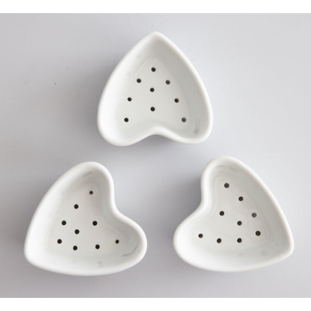 A charming set of three vintage french ironstone heart-shaped cheese mold dishes. They were traditionally used in France...