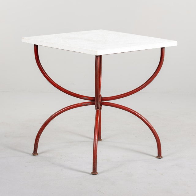Found in Italy, this rustic table with a white limestone top and red metal base dates from the 1970s. Substantial iron...