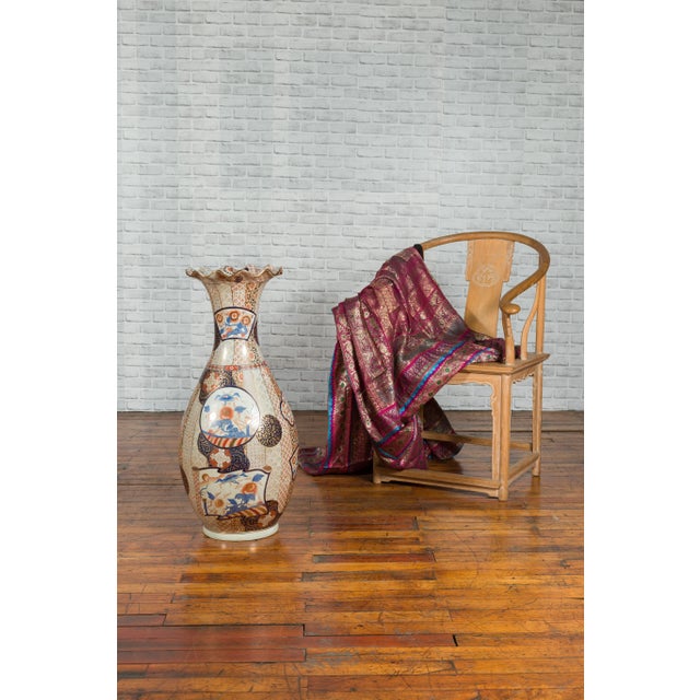 A vintage Chinese tall vase from the mid-20th century, with hand painted decor. Created in China during the midcentury...