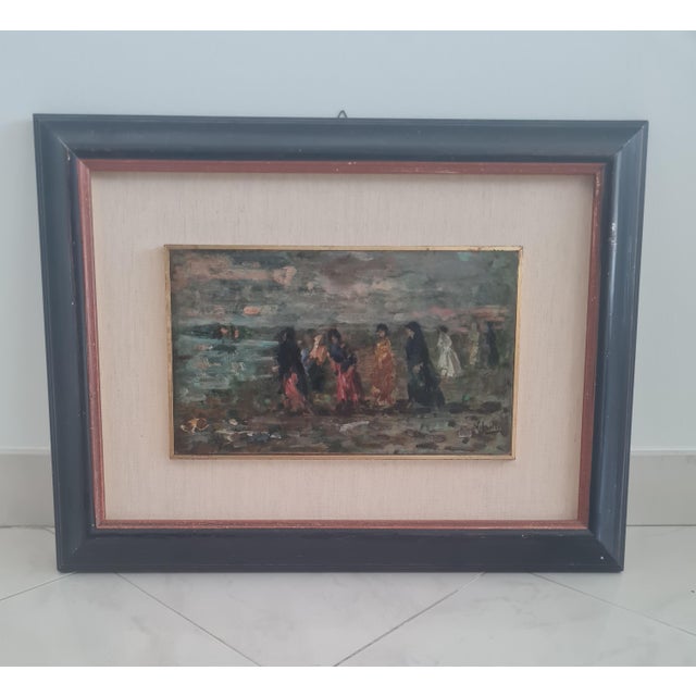 A highly atmospheric early 20th-century oil painting signed v. Irolli, depicting figures walking along a coastal promenade...