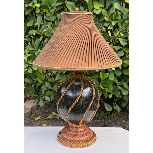 Vintage Maitland-Smith table lamp featuring a sculptural ovoid body with a black faux-marble finish, accented by twisted...