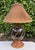 Vintage Maitland-Smith table lamp featuring a sculptural ovoid body with a black faux-marble finish, accented by twisted...
