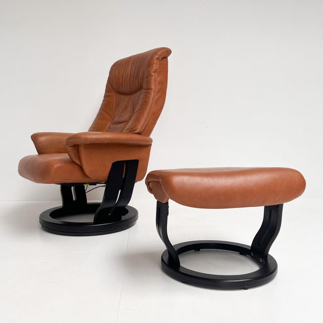 Very comfortable and stylish Danish design recliner with matching ottoman from the quality brand Hjort Knudsen. The set...