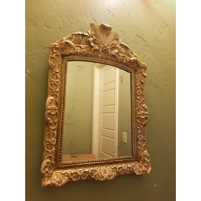 Beautiful antique French regency mirror with beautiful carved details and weathered Giltwood finish with undertone of...