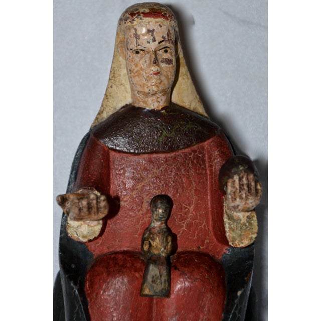 Featured is an antique hand-carved polychromed Monserrat Virgin of Catalonia, Spain. The Virgin Mary is depicted seated,...