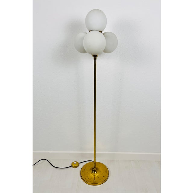 A midcentury floor lamp by Kaiser made in Germany in the 1960s. It is fascinating with its Space Age design and four ball...