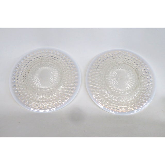 This beautiful Pair of Plates is made of glass. Due to the material and style, we believe this gorgeous pair was made by...