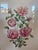 A hand colored engraving of Queen Elizabeth roses. It is a vertical arrangement of blooming pink roses and rose buds with...
