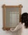 Carved oak window-pane mirror in Weathered Honey Oak. The weathered honey oak surface highlights mullioned glass panes,...