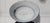 A unique ceramic bowl featuring blue floral motifs; the maker's name is hand-painted on the underside. This is a...