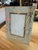 A vintage Italian picture frame featuring an elegant reverse-painted glass panel decorated with delicate gilt botanical...