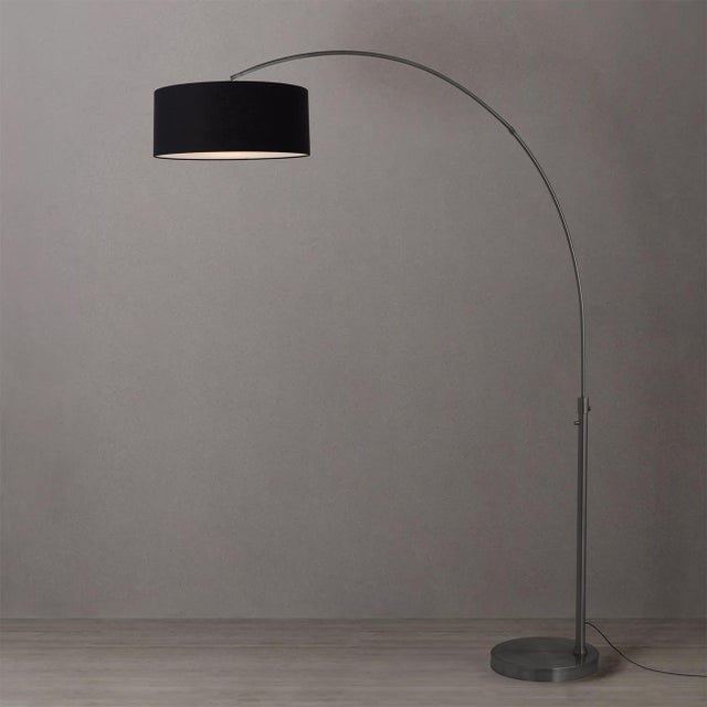 The Float Arc Lamp is a Peter Morelli-designed modern arc lamp with a black nickel steel body and base, accentuated by a...