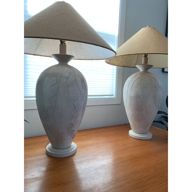Gorgeous pair of 1989 white plaster lamps with abstract tribal bird in great original condition. Complete with original...