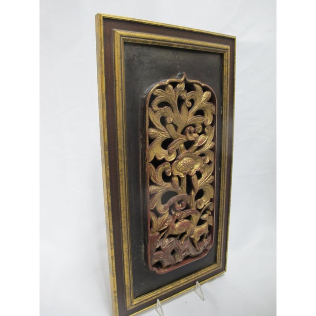 Chinese Qing Dynasty carved wood panel with relief figures of flora and fauna. Red lacquer and gilt accents. Elaborate...