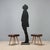 Pair of vintage 1950s stools featuring tapered beech wood legs with seats upholstered in brown faux leather, a material...