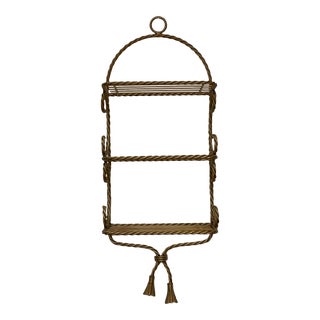 1960s Hollywood Regency Metal Rope and Tassel 3-Shelf Wall Mounted Shelving Unit. For Sale