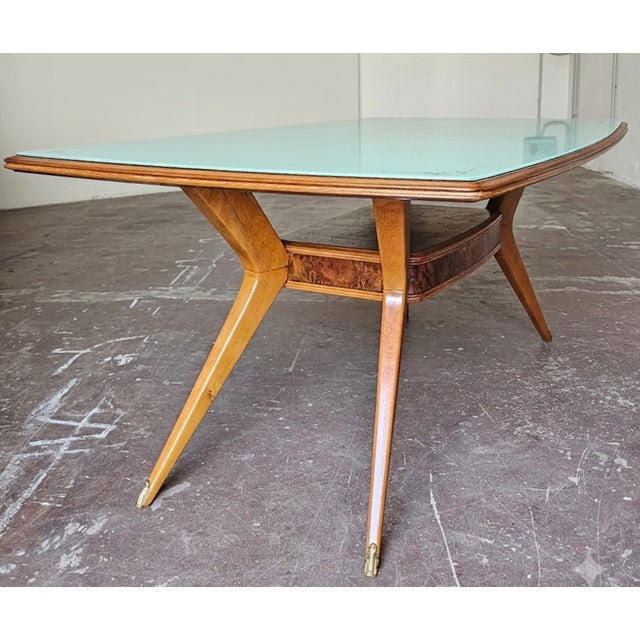 Splendid original Italian dining table from the 1950s. Glass top with gold-plated trim. Wooden base with central burl wood...