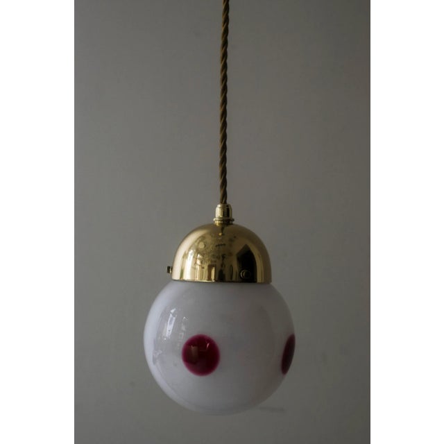 This Viennese hanging lamp was designed by Koloman Moser and produced by Bakalowits & Söhne circa 1905. The glass...