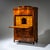 Biedermeier secretary desk veneered in walnut, featuring three lower drawers, a flat fall-front writing surface, and a top...