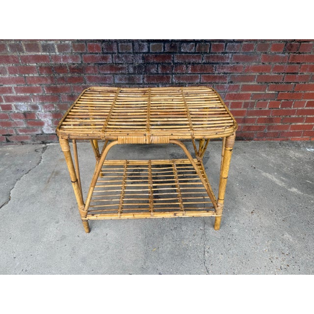 Transform your living space with this exquisite vintage mid-century Italian bamboo and rattan coffee table, a stunning...