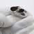 A charming vintage miniature depicting a baby shoe with floral decoration, handmade in Continental Silver (800/000) in...