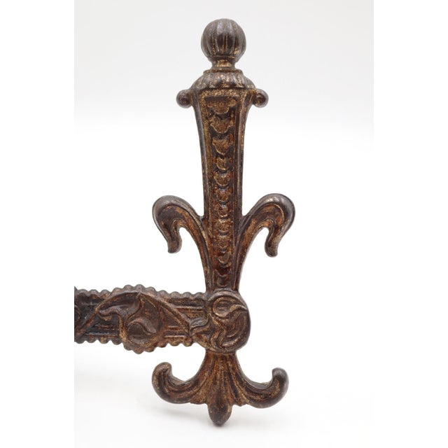 Victorian style double arm hall tree hook made of cast iron with a bronze finish. There is a mounting screw with a nut...