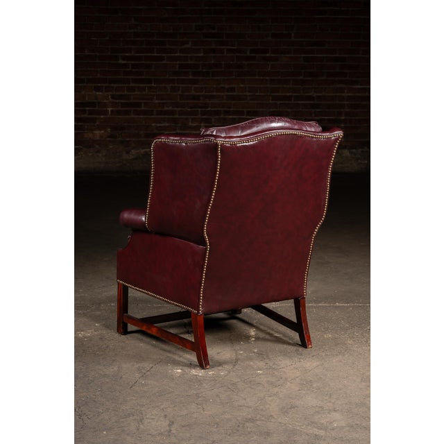 Animal Skin Mid 20th Century Tufted Leather Wingback Chesterfield Armchair With Ottoman in Oxblood For Sale - Image 7 of 15