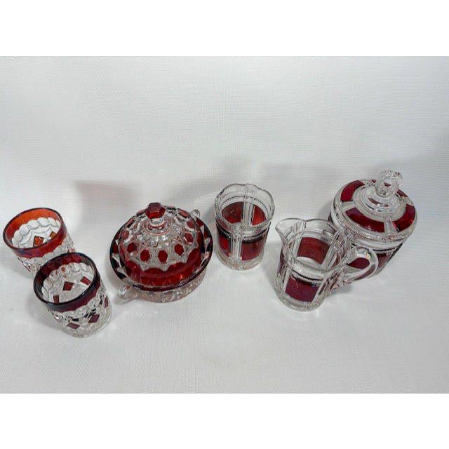 A beautiful museum-quality set featuring six pieces of 19th century Early American Pattern Glass (EAPG) with a rich ruby...