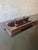 An elegant antique rosewood desk stand featuring three lidded inkwells, silver-mounted decorative accents, and richly...
