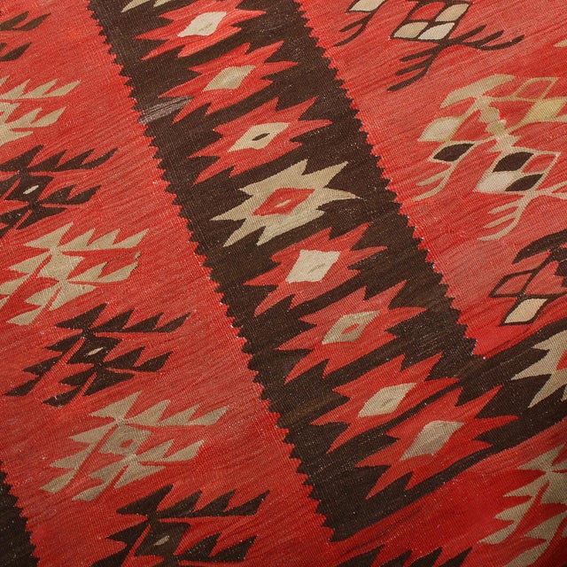 Hand-woven in Turkey, originating between 1950 and 1960, this vintage mid-century wool kilim hails from the Pirot, also...