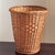 Offering a lovely handwoven natural wicker wastebasket from the mid-20th century. In addition to being highly functional,...