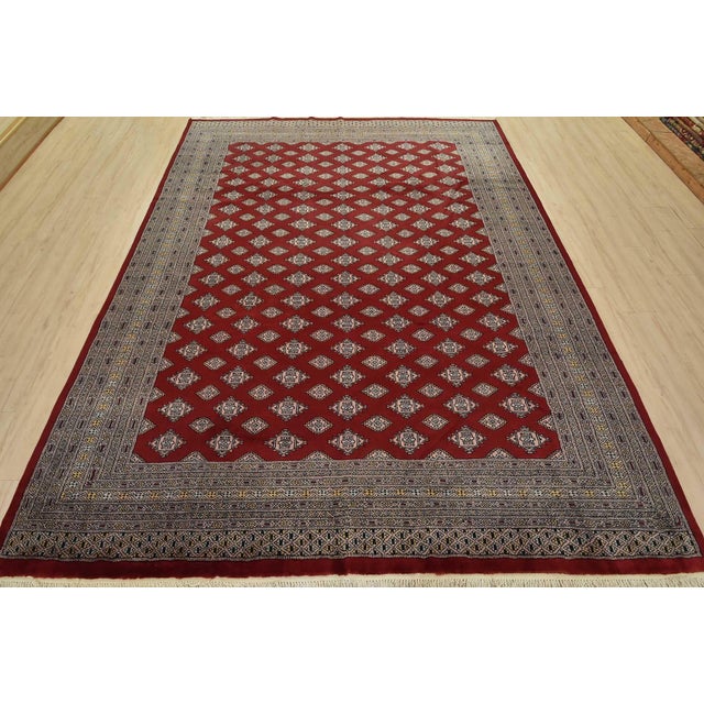 A tribal Bokhara Jaldar rug hand-knotted with fine wool on a cotton foundation. This rug features rows of repeating...