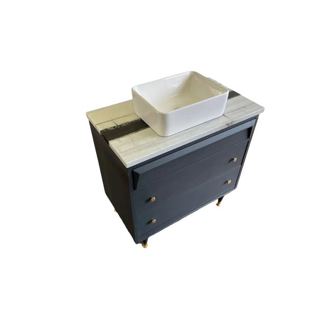 A stylish Mid-Century Modern dresser converted into a distinctive single-sink bathroom vanity. Measuring 32 inches wide,...