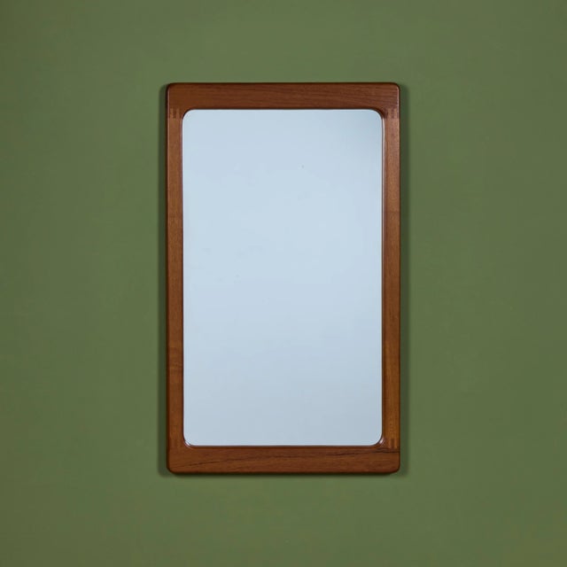 Rectangular teak framed wall mirror by Pedersen and Hansen c.1960s, Denmark. The Danish mirror features an oiled teak...