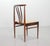 Set of four rosewood spindle back Scandinavian design dining chairs. This solid set features caramel leatherette seatings....