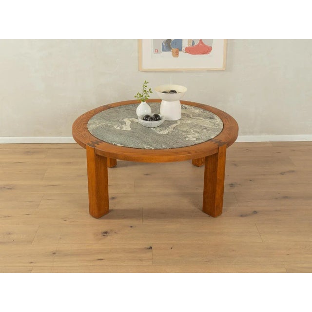 Classic coffee table from the 1970s. High-quality solid oak frame with a marble tabletop in cream and gray tones. Quality...