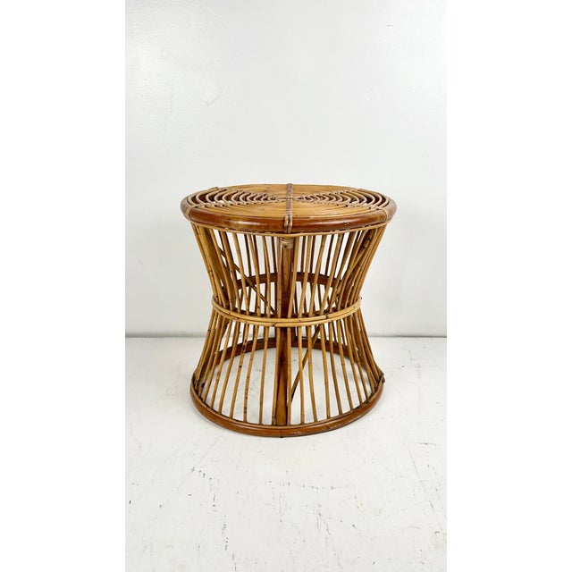 Vintage pencil reed rattan round side table. Round spiral top with cane wrapping. Great occasional table, or as a garden...