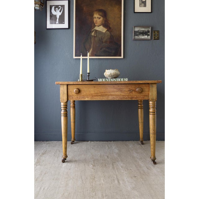 A 19th-century scrubbed pine farmhouse desk with a beautifully aged surface and patina from daily utilitarian use. The...