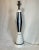 Elegant tall, slender art glass table lamp in a Deco Modern form. Black and white with gold and brass accents. Circa...