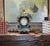 This Ansonia mantle clock, crafted in the rococo style, features a black metal case with cast iron or bronze mounts and...