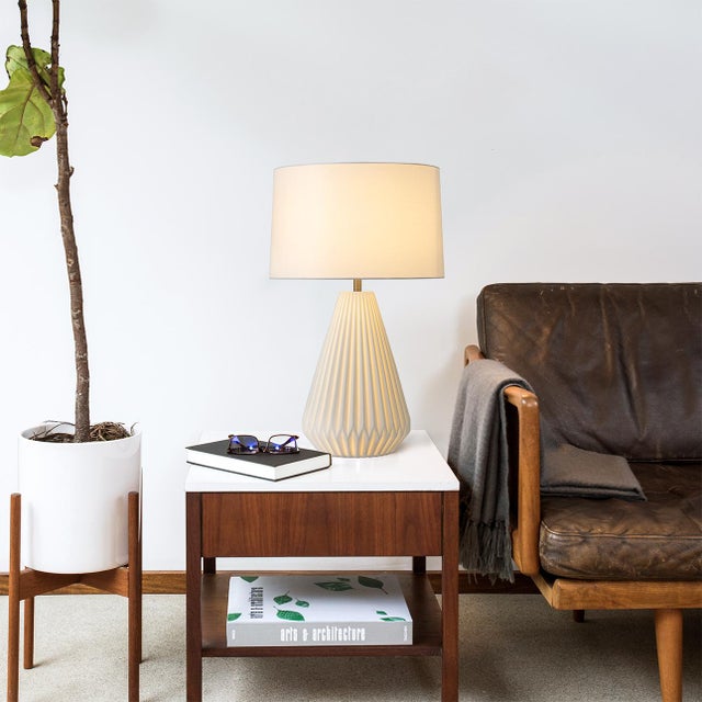 The Concord Table Lamp embodies an emphasis on clean lines, elegant shape, and functionality in its design. With a...