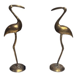 A Pair of Vintage Solid Brass Crane Figurines Standing Gracefully on Round Bases With a Warm, Aged Patina. For Sale